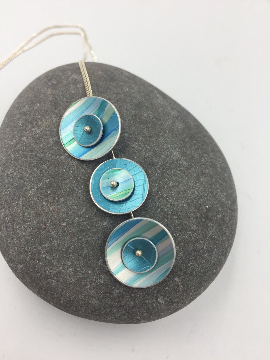 Anodised aluminium daisy chain necklace in shades of green blue