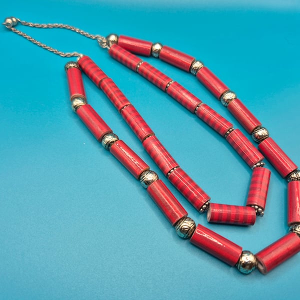 Double stranded long necklace with red lined tubular paper beads