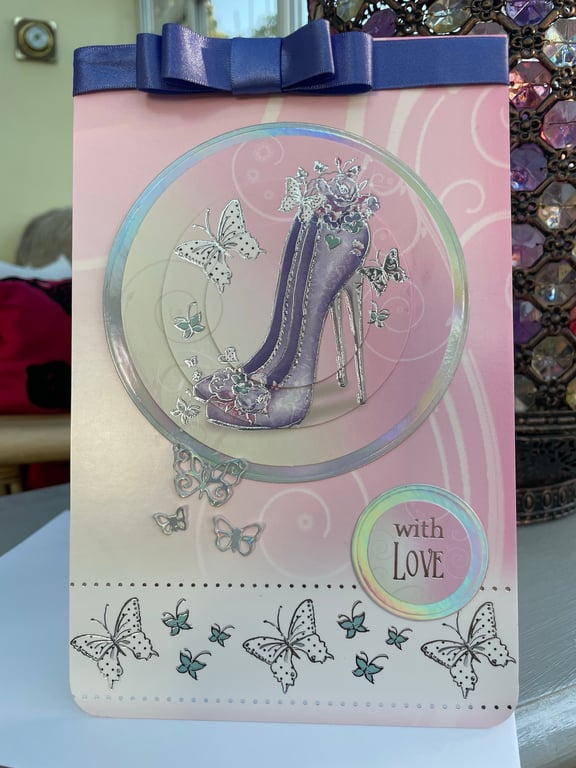 High heel shoes and butterfly with love card