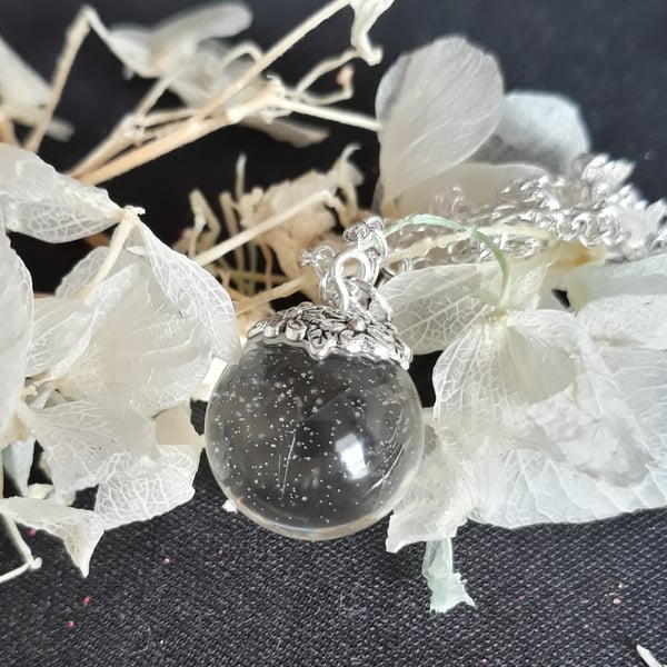 R20 Clear resin globe necklace with sparkles