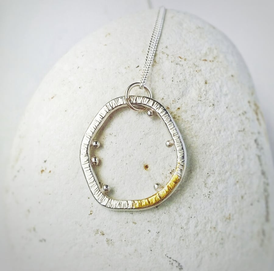 A pretty sterling silver necklace inspired by Lichen with a gold ascent 
