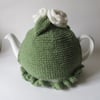 Hand knitted green tea cosie with cream roses 