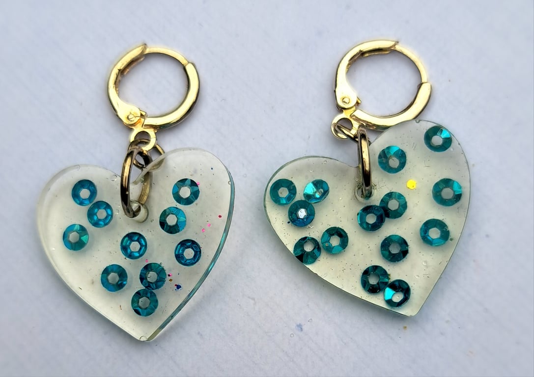 Heart shaped pair of resin with blue sequins