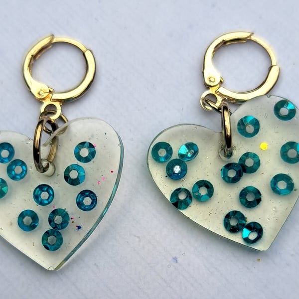 Heart shaped pair of resin with blue sequins