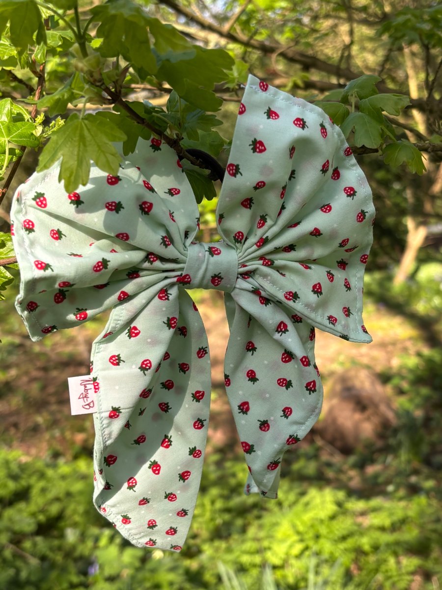 Hair bow on band in strawberry print
