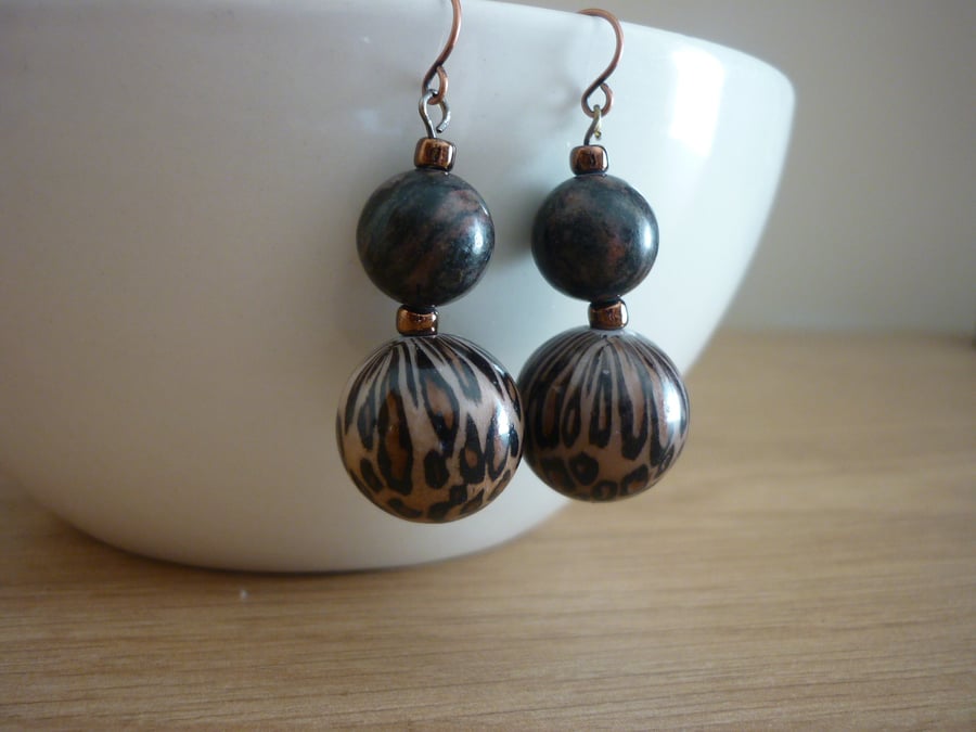 ANIMAL PRINT AND ANTIQUE COPPER EARRINGS.