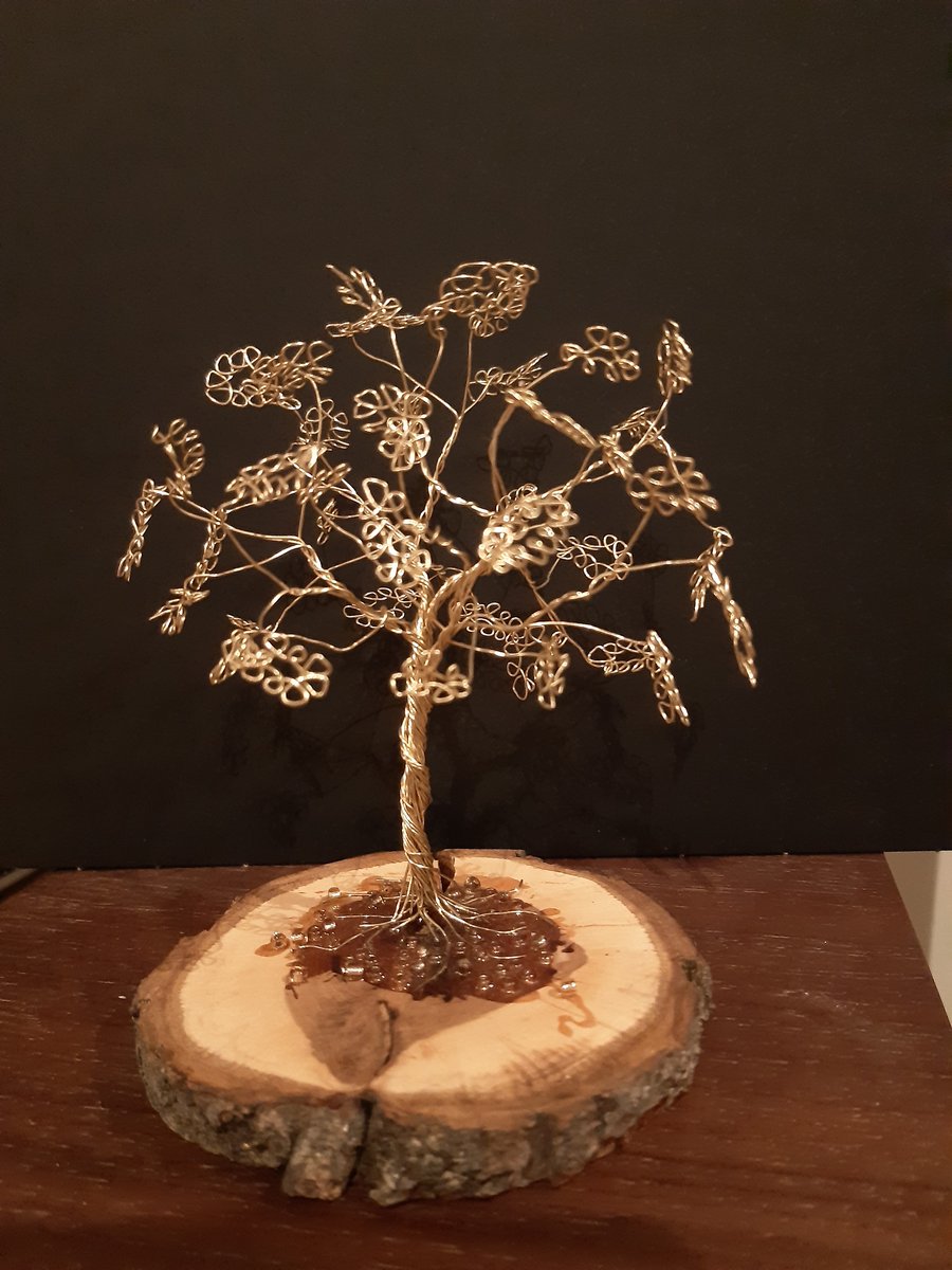 metal wire made into a lovely tree set on a wooden base 