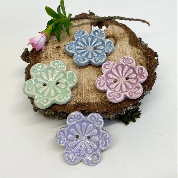Set of four flower shaped ceramic handmade buttons pastels