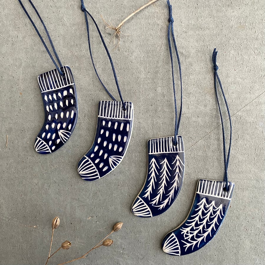 Set of four ceramic sock decorations .