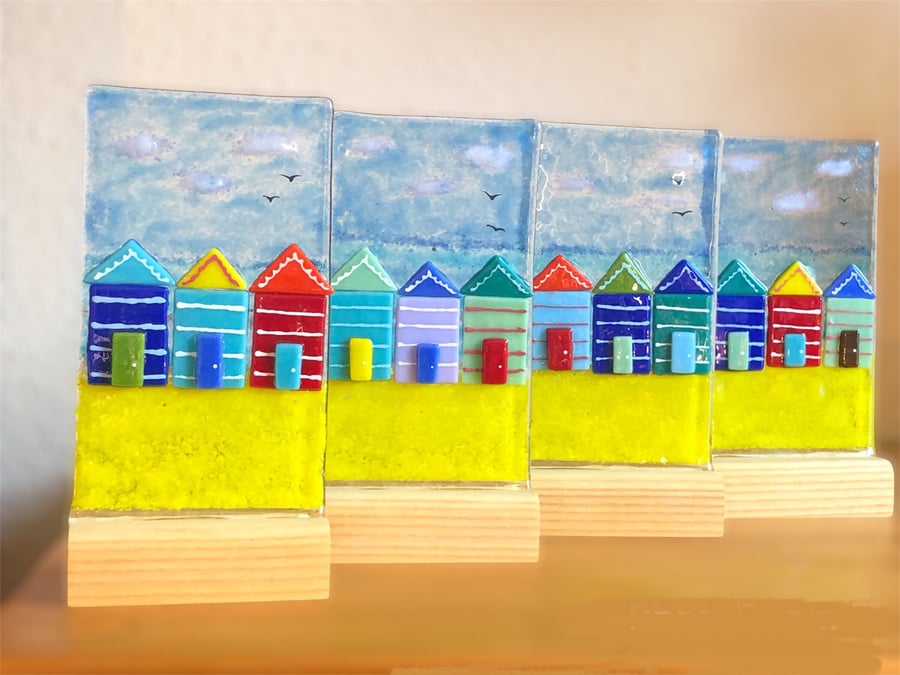 Fused glass free standing ornament sun catcher beach huts on a wooden stand 