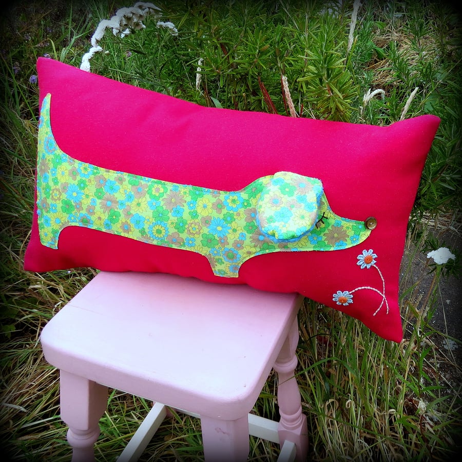 A ditzy floral dachshund cushion. 54cm in length.  With inner pad.