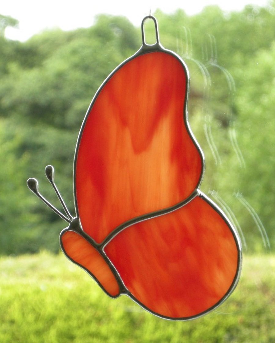 Stained Glass suncatcher Butterfly in an amber and red streaky opalescent glass