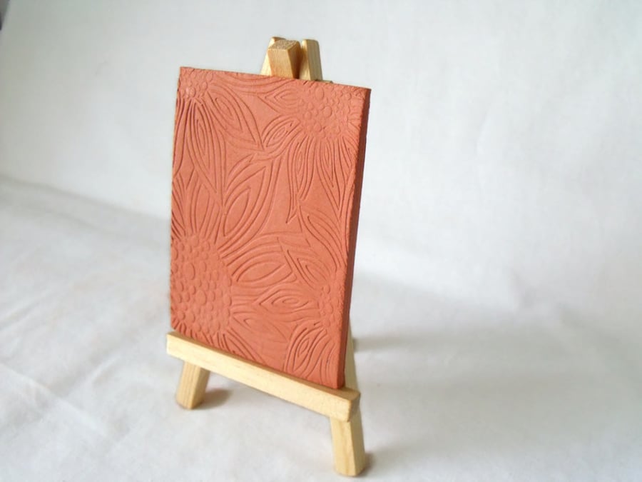 terracotta impressed clay tile displayed on an easel, number 6 of 8 available