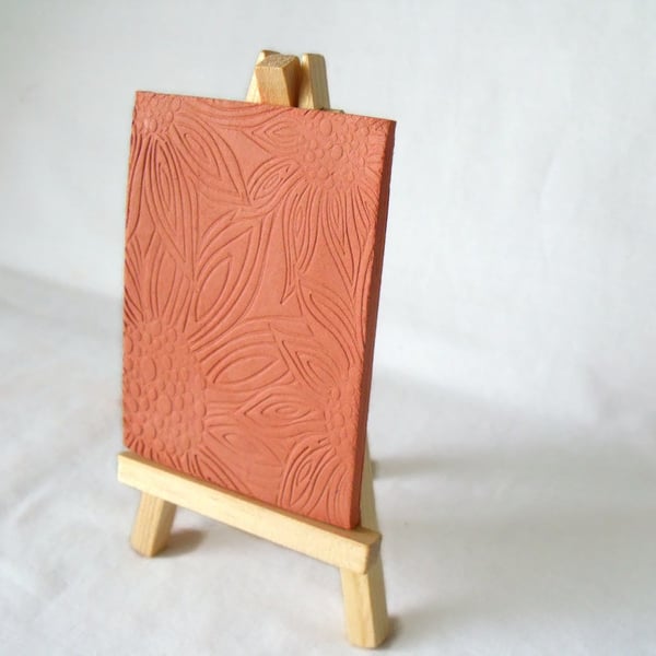 terracotta impressed clay tile displayed on an easel, number 6 of 8 available