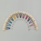 Silver plated cowrie shell & macramé spiral earrings with 13 colour options.