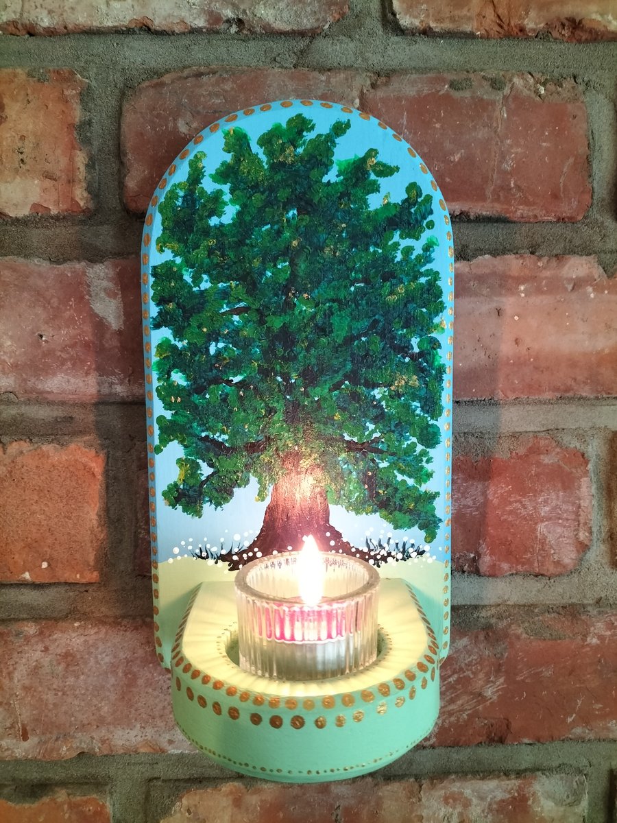 A wall mounted candle holder for a tealight