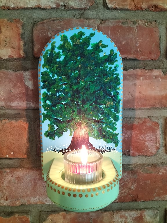 A wall mounted candle holder for a tealight