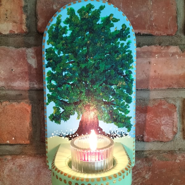 A wall mounted candle holder for a tealight