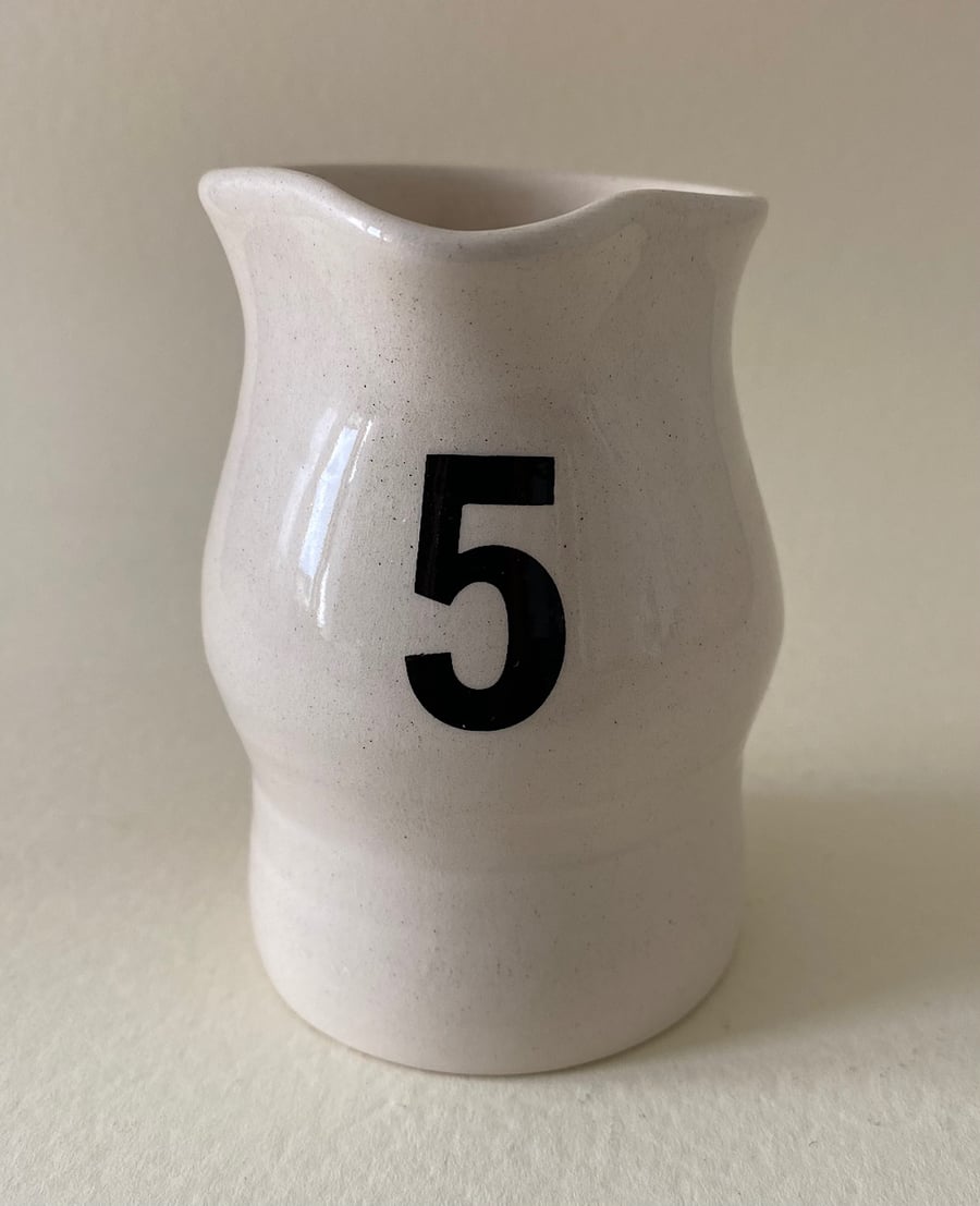 5. Number five ceramic handmade cup.