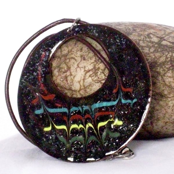 large pierced,circle scrolled brick-red, light blue, yellow, green on black