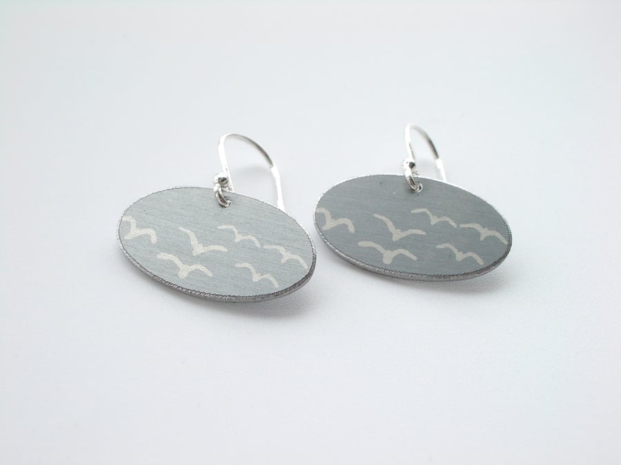 Grey oval earrings with seagull print. Perfectly imperfect.