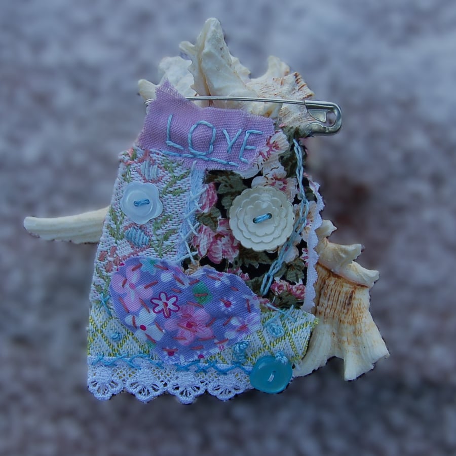 Upcycled Textile art hand stitched charm brooch in a romantic style.