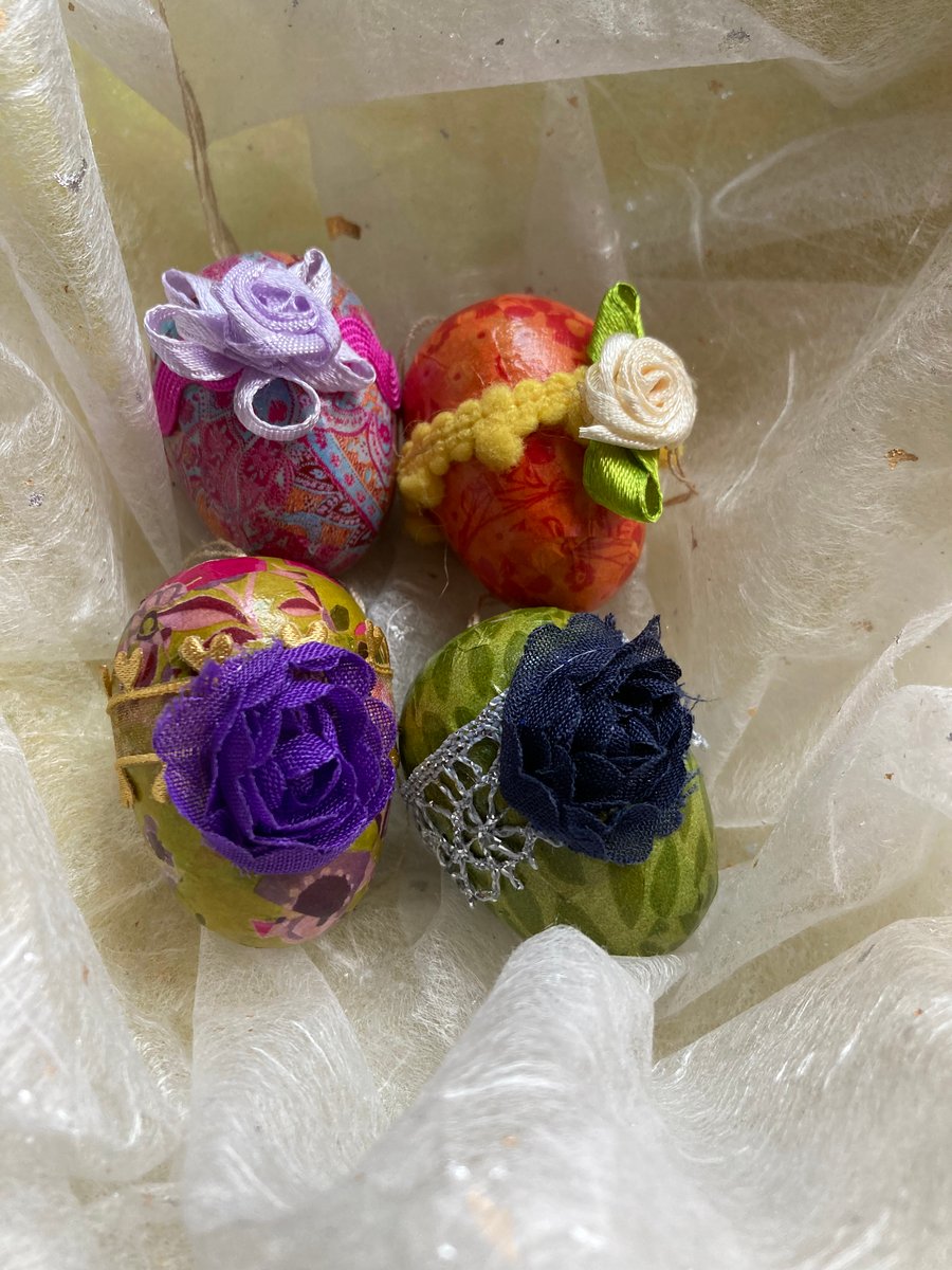 4 solid wooden decorated eggs