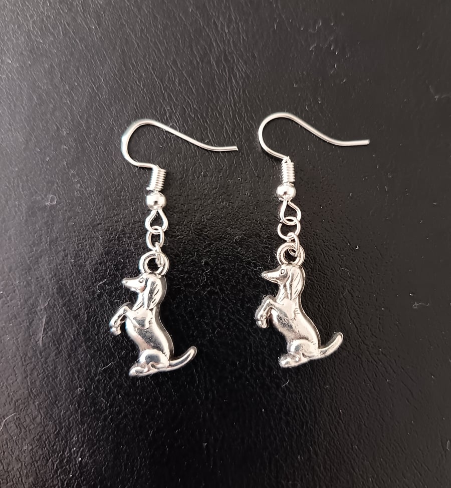 Silver dog charm dangle earrings 
