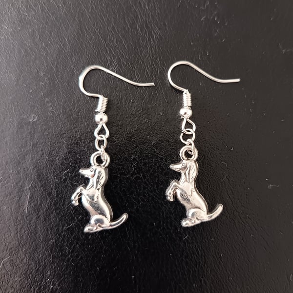 Silver dog charm dangle earrings 