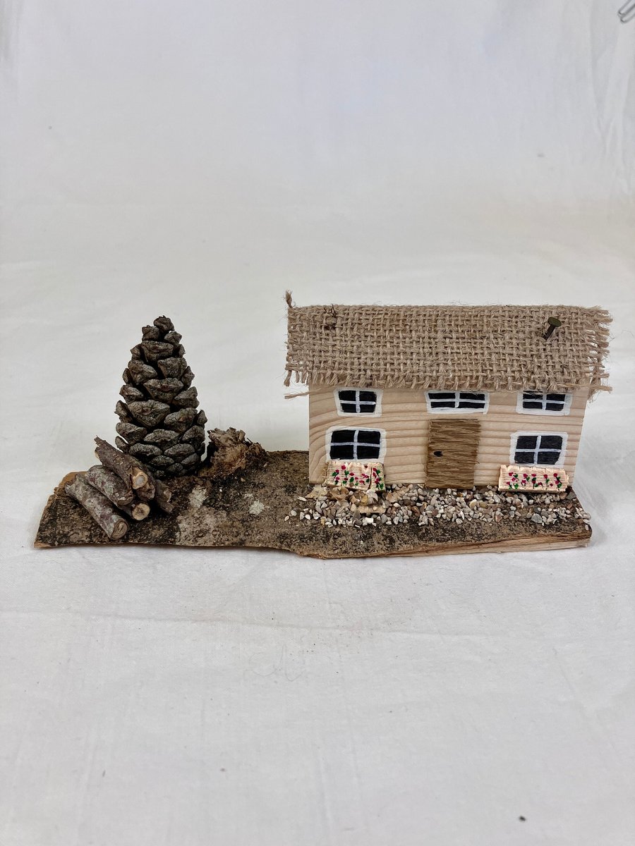 Handmade small thatched-style wooden house ornament. Handmade wooden gift. Hand-