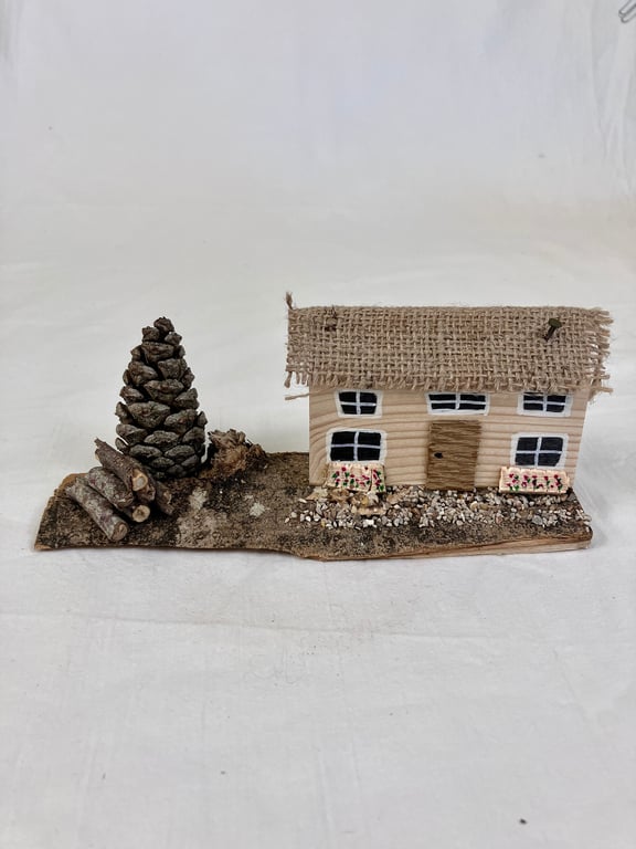 Handmade small thatched-style wooden house ornament. Handmade wooden gift. Hand-