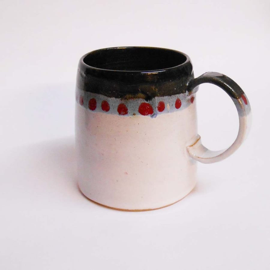  Mug larger white with spots.