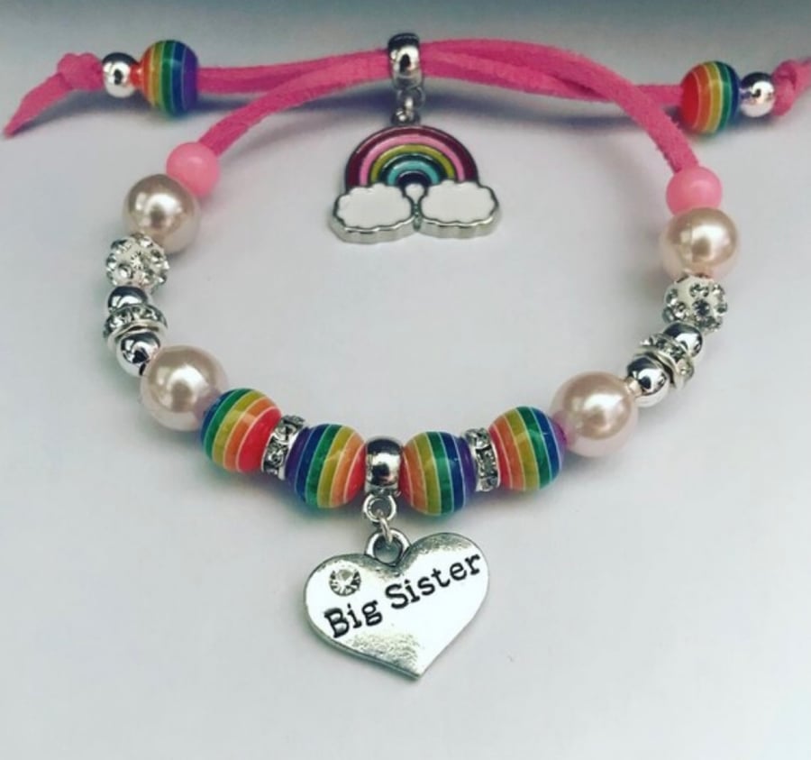 Big sister pink suede effect corded rainbow charm bracelet 