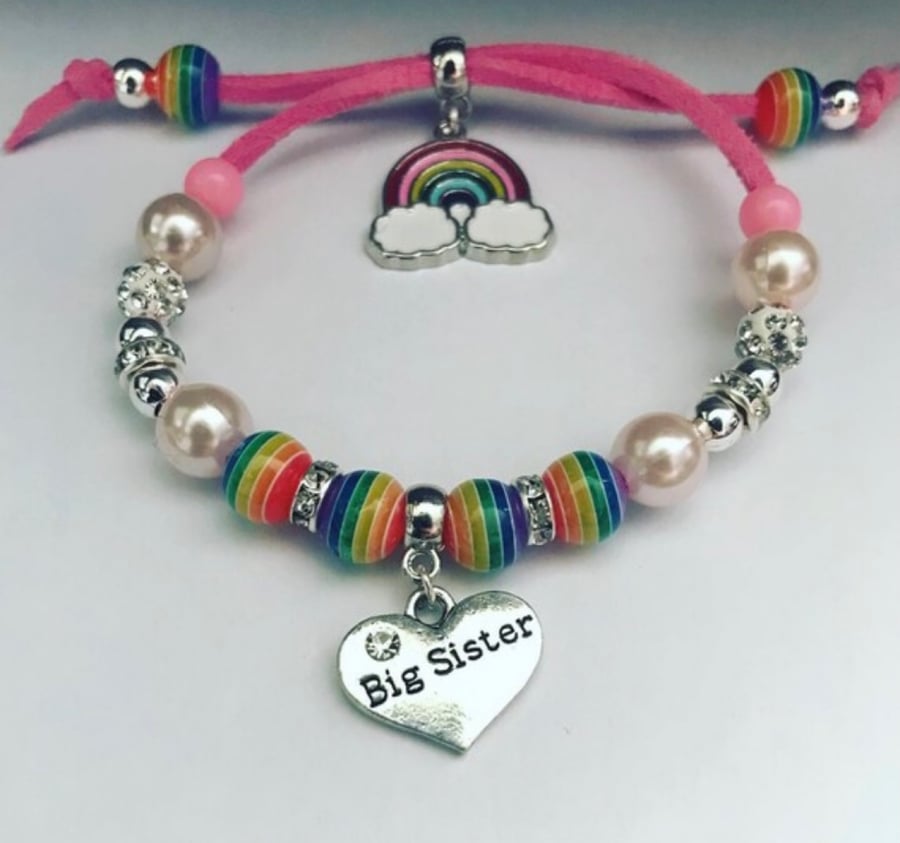 Big sister pink suede effect corded rainbow charm bracelet 