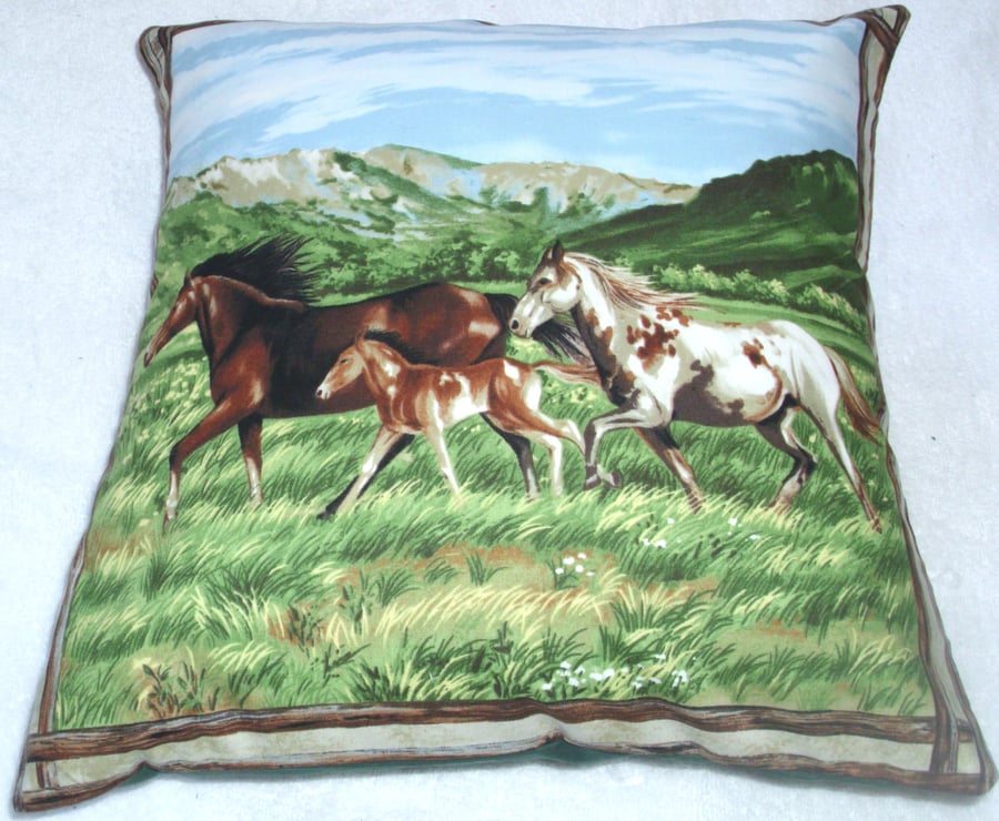 Two horses and a foal trotting across a valley cushion 