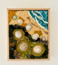 Hand embroidered artwork incorporating seashells - beach strandline