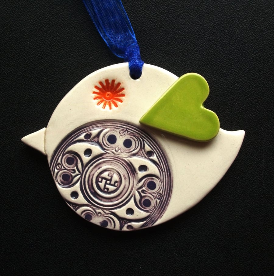 Ceramic patterned bird decoration with heart shaped wing