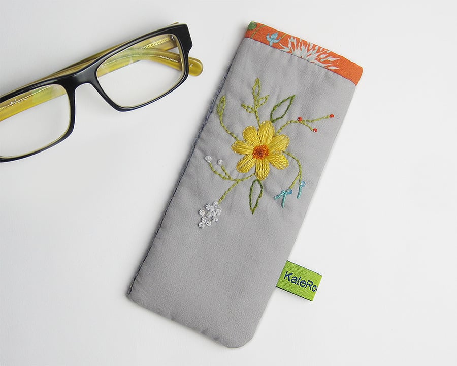 Grey glasses case with hand embroidered spring flowers and orange trim