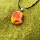 Yellow and orange glass necklace.