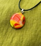Yellow and orange glass necklace.