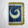      Needle case with appliquéd bird and crochet trim