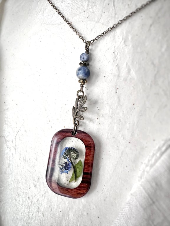 Forget Me Not Wood and Resin Pendant with an  Antique Brass Plated Chain.
