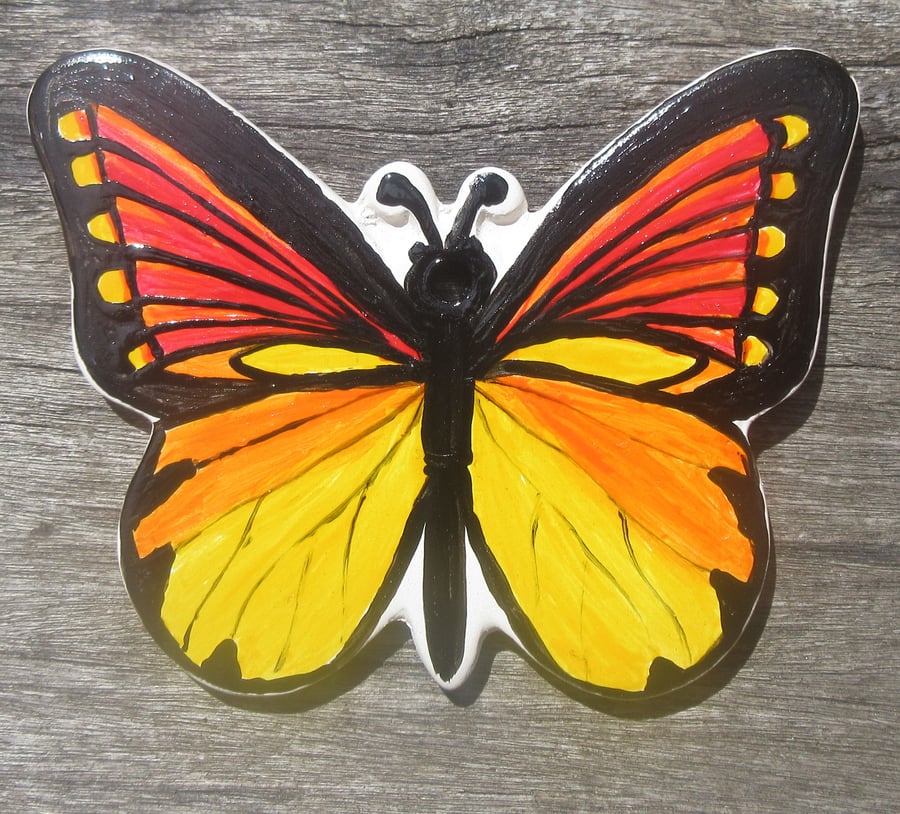 Hand painted ceramic butterfly in yellows, oranges, reds and black