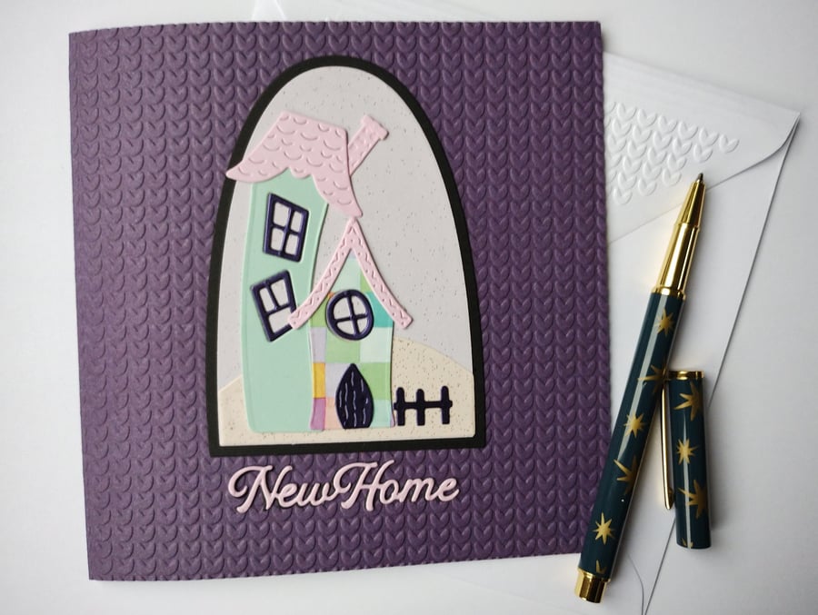 New Home Card - whimsical house with on a purple knitted effect embossed card