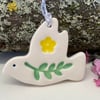Teeny ceramic dove decoration with leaves and yellow flower