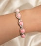 Rhodochrosite stretchy beaded bracelet with silver colured connectors - Image 1