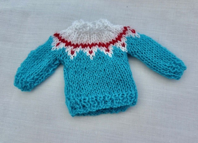 Tiny miniature knit jumper in fine yarn with patterned yoke for the dolls house