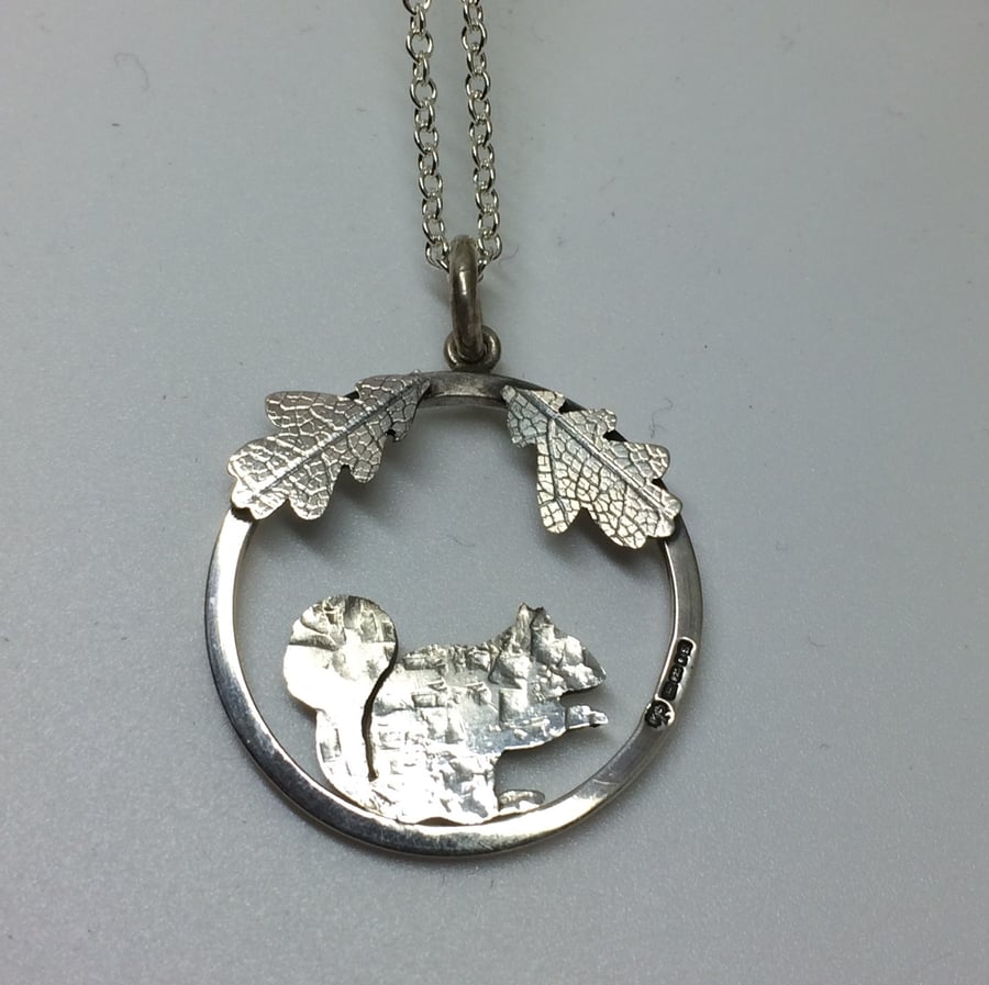 Squirrel pendant with oak leaves