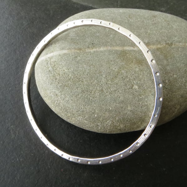 Contemporary square wire bangle with dotty pattern