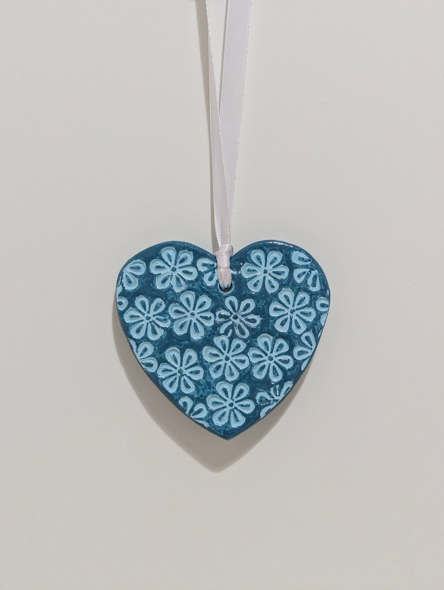 Teal clay heart hanging decoration embossed with flowers